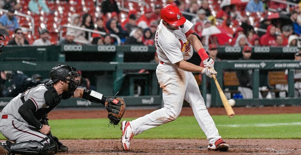 Cardinals Player Hitting Baseball